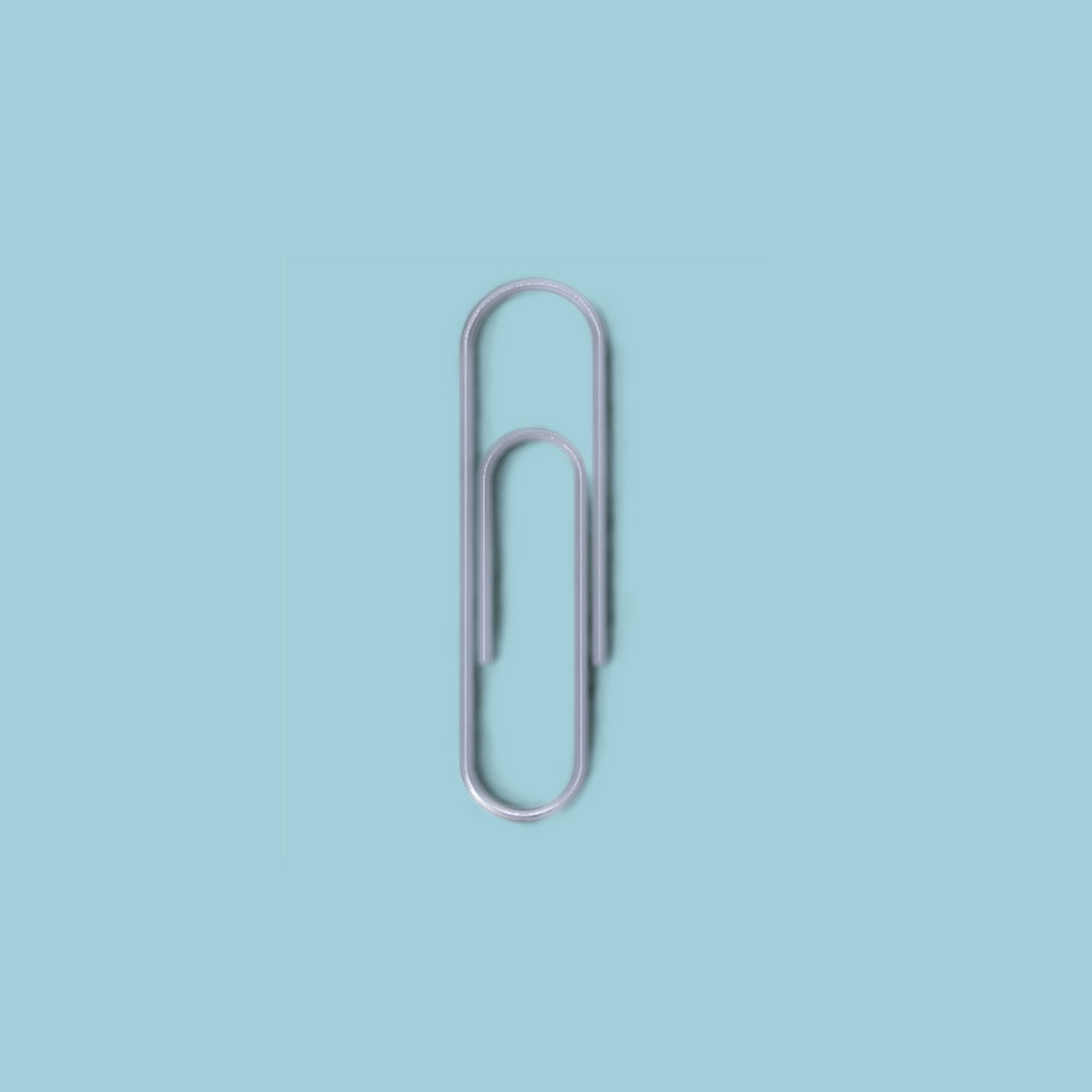 Paper clip on pastel blue background