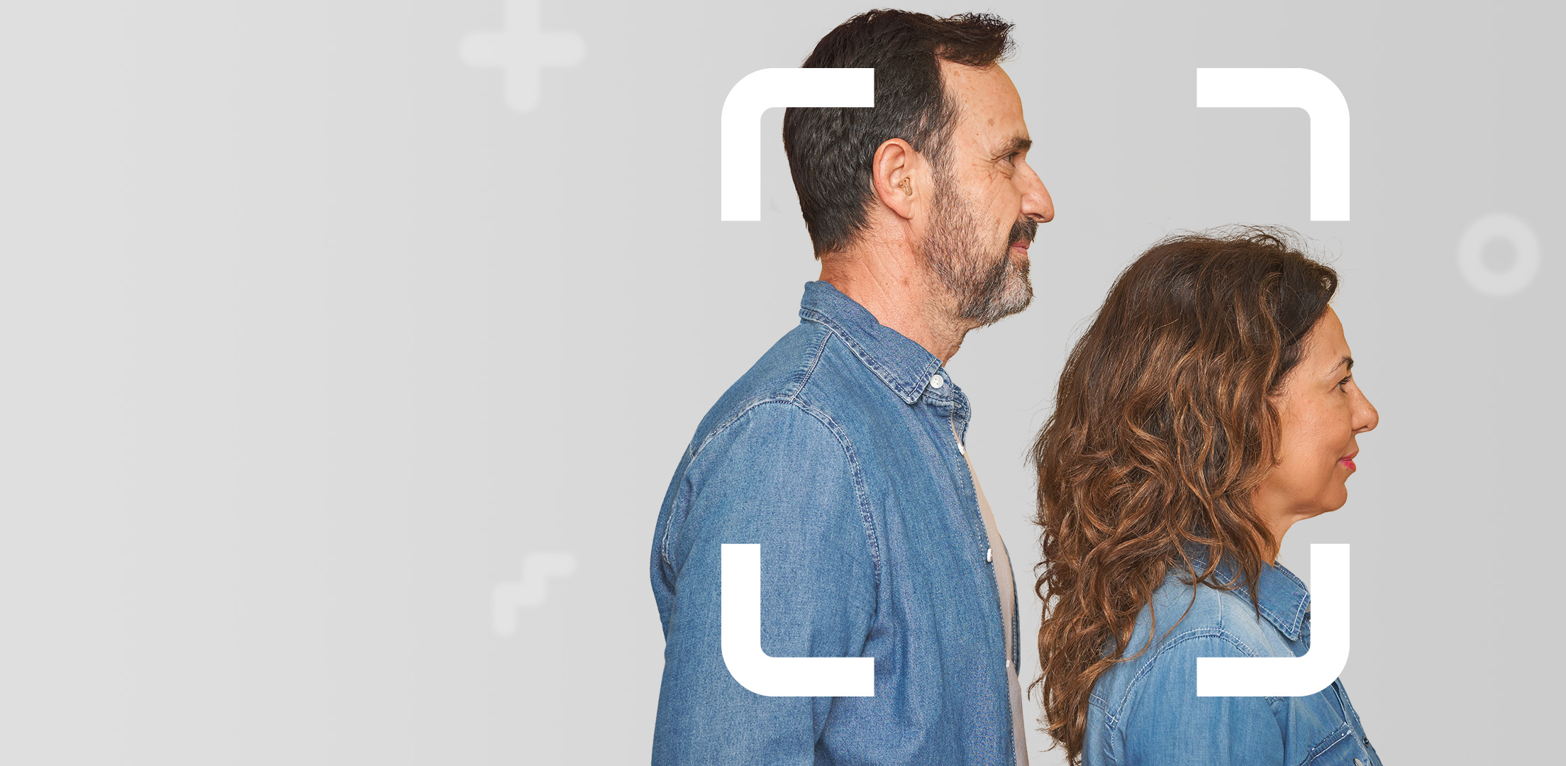 Middle aged couple facing sideways both dressed in denim focusing on their personal savings future
